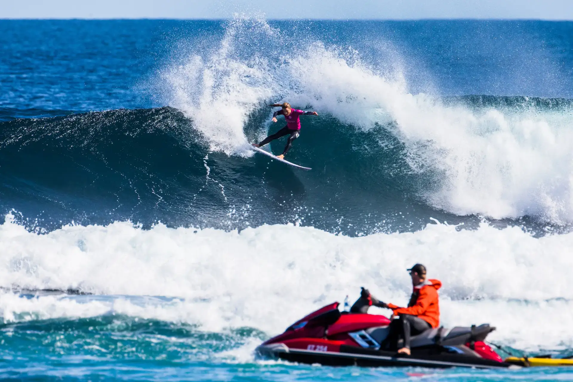 VanDijk surfing with jet ski in foreground